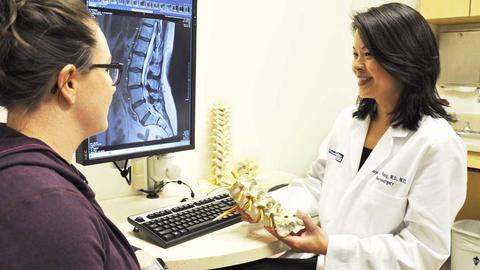 Doctor holding spine