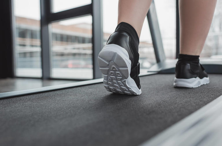 close-up-overweight-girl-feet-treadmill-gym