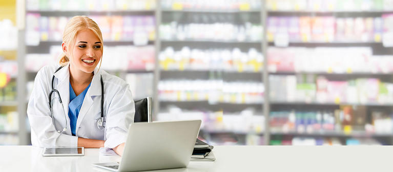 Pharmacist at Counter with Computer