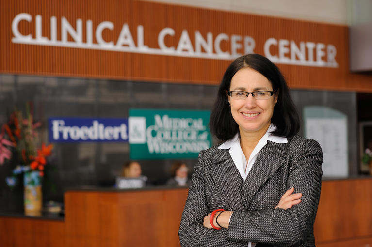 Dr. standing outside of Clinical Cancer Center 
