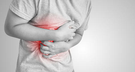 Man clutching stomach in pain