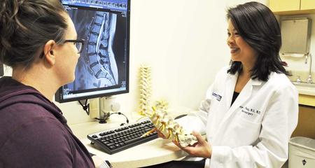 Doctor holding spine