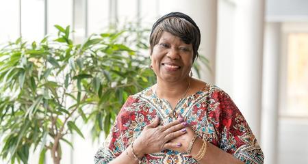 Liver Transplant Patient, Cecelia Dukuly, smiling with hands over heart