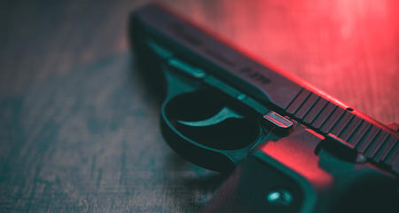 Handgun with red light background, gun violence prevention concept