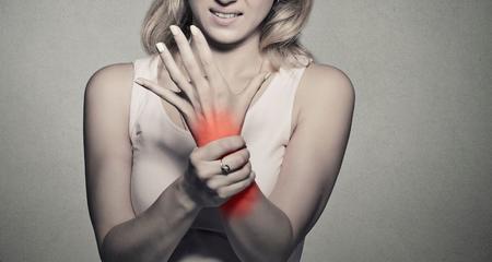 Women holding wrist in pain