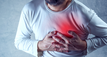 Man clutching chest for heart pain