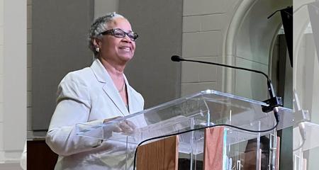 Rev. Trinette McCray  speaking at a podium