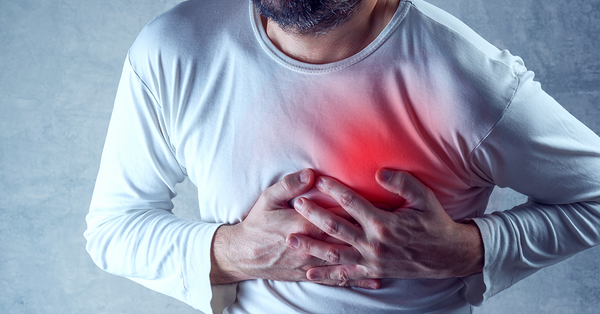 Man clutching chest for heart pain